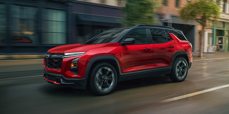 Red SUV driving through city street