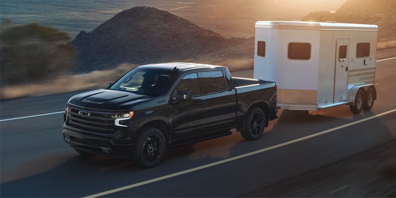 2026 Chevrolet Silverado 1500 towing a trailer near St. Clairsville, OH demonstrating 13,300 lbs. maximum towing capacity
